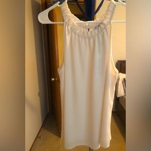 Light weighted blouse with cute ruffled neck detail.